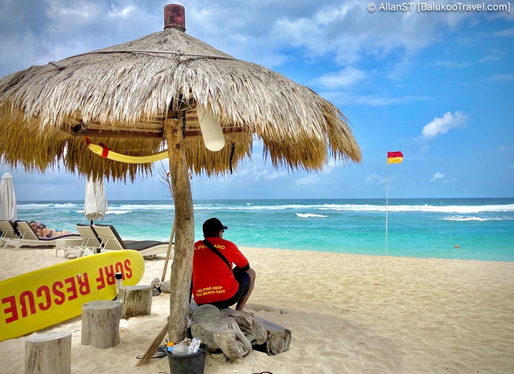 Soft white sand of Melasti Beach is set against tall cliffs