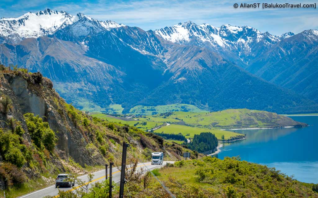 Breathtaking panoramic views of the deep blue lake set against a backdrop of rugged mountains Breathtaking panoramic views of the deep blue lake set against a backdrop of rugged mountains